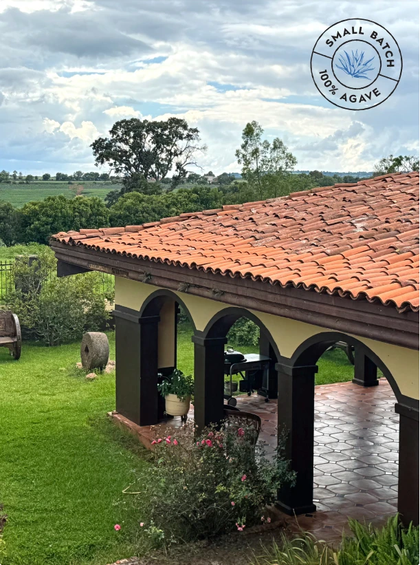 Hacienda La Esperanza courtyard with terracotta roof overlooking agave fields, small-batch 100% agave seal