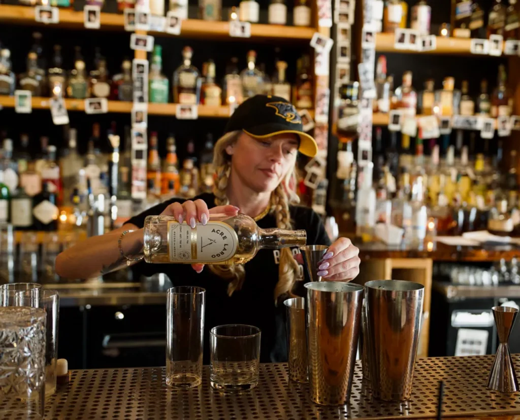 a bartender pours acre largo tequila blanco at barrel shop nashville